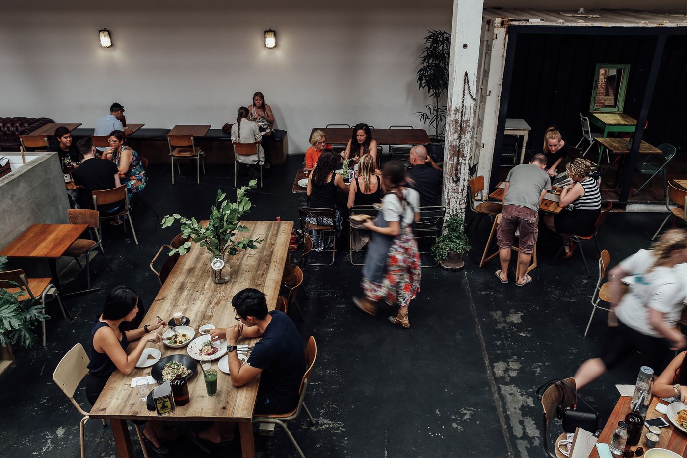 A busy restaurant during service with guests dining and staff working